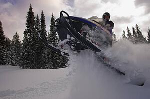 Man jumping a snowmobile