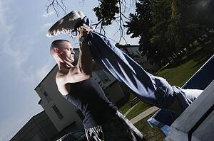 Man holding a person by the legs