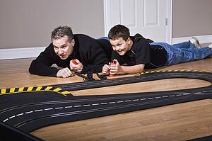 Father and son playing with racetrack