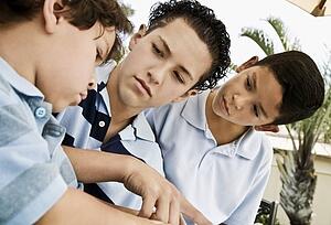 Three boys working together