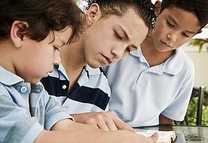 Boys reading together