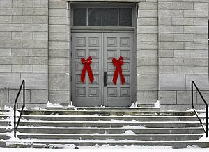 Red bows on doors of a grey building
