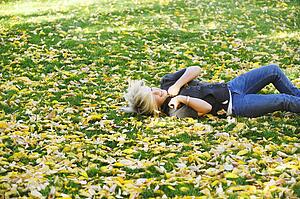 Teenage girl rolling down a hill