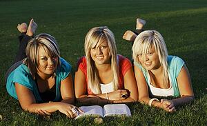 Three girls reading together