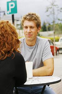 Man looking at woman at outdoor cafe
