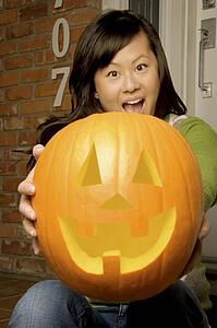 Girl holding jack-o-lantern
