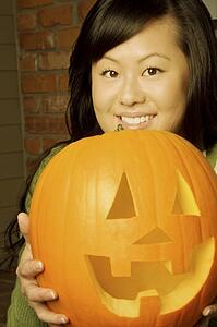 Girl holding a jack-o-lantern