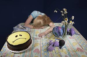 Upset girl surrounded by party supplies