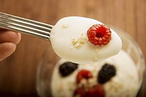 Berry and yogurt on a spoon