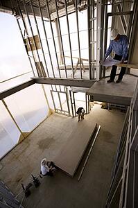Foreman and drywallers at a construction site