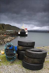 Used tires and lobster traps on waters edge, Lochaline, Scotland