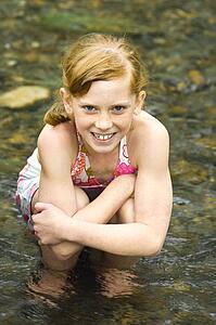 Girl sitting in water