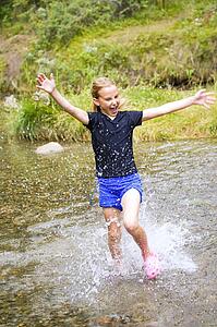 Girl running through water 