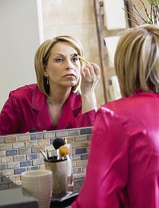 Woman applying makeup