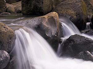 Water flowing over rocks, Napali Coast State Park, Kauai, Hawaii