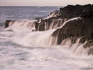 Waterfalls flowing into the ocean, Kauai, Hawaii