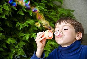 Boy playing with bubbles