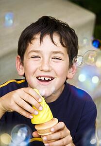 A boy playing with bubbles