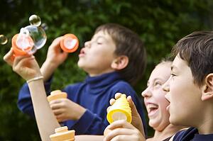 Children blowing bubbles