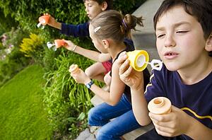 Children blowing bubbles