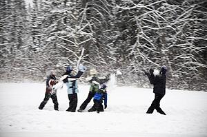 A group of children having a snowball fight