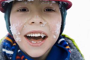 Boy with snow on face