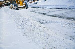 Tractor clearing a snow covered road