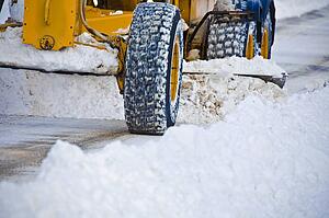 Snow plow clearing road