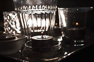 Lit candles and glassware