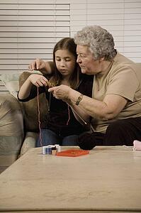 Grandmother and granddaughter knitting