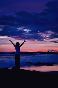 Woman on a beach at sunset 