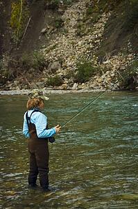Boy fly fishing, Nordegg, Alberta, Canada 