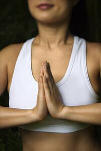 Woman in fitness attire standing in yoga position
