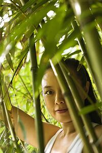 Portrait of Asian American woman in bamboo forest in Maui, Hawaii.