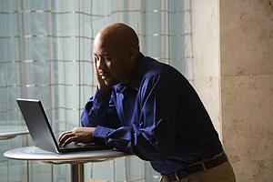 Male typing on laptop computer 