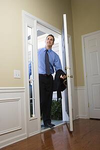 Businessman at open door with briefcase