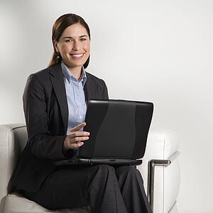 Business woman sitting working on laptop