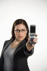 Professional business woman taking picture of self with camera phone