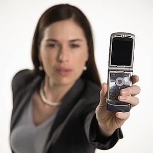 Professional business woman taking picture of self with camera phone