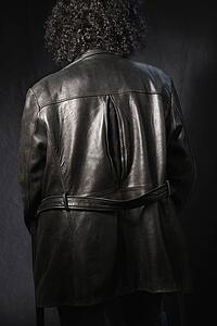 Back view of woman with curly hair wearing black leather jacket