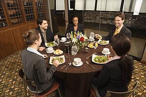 High angle of diverse group of businesspeople in restaurant eating