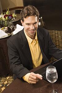 High angle view of businessman with laptop in restaurant