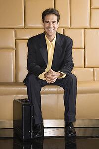Businessman with briefcase smiling at viewer