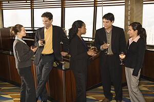 Businesspeople in bar drinking and conversing