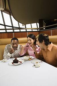 Small group of friends eating dessert at a restaurant