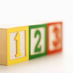 Selective focus of fow of toy building blocks with numbers.