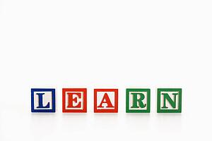 Alphabet toy building blocks spelling the word learn.