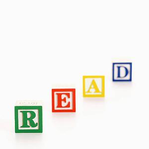 Alphabet toy building blocks spelling the word read.