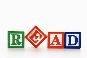 Alphabet toy building blocks spelling the word read.