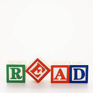 Alphabet toy building blocks spelling the word read.